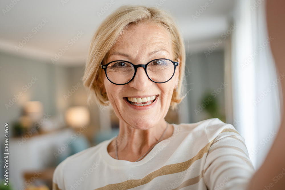 Portrait of one mature blonde caucasian woman with eyeglasses at home Portrait of one mature blonde caucasian woman with eyeglasses at home