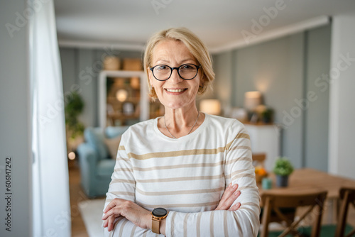 Portrait of one mature blonde caucasian woman with eyeglasses at home