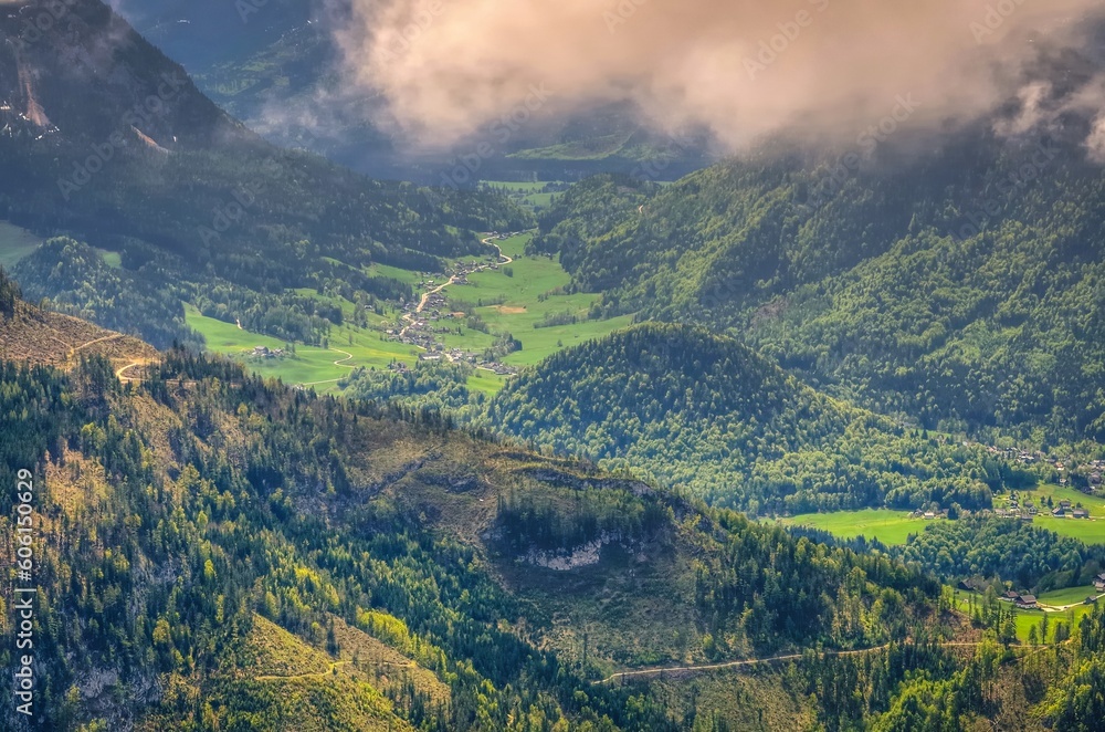 Road in Austrian mountains. Road winding above the valley and village, view from Loser peak in Dead Mountains (Totes Gebirge) in Austria.