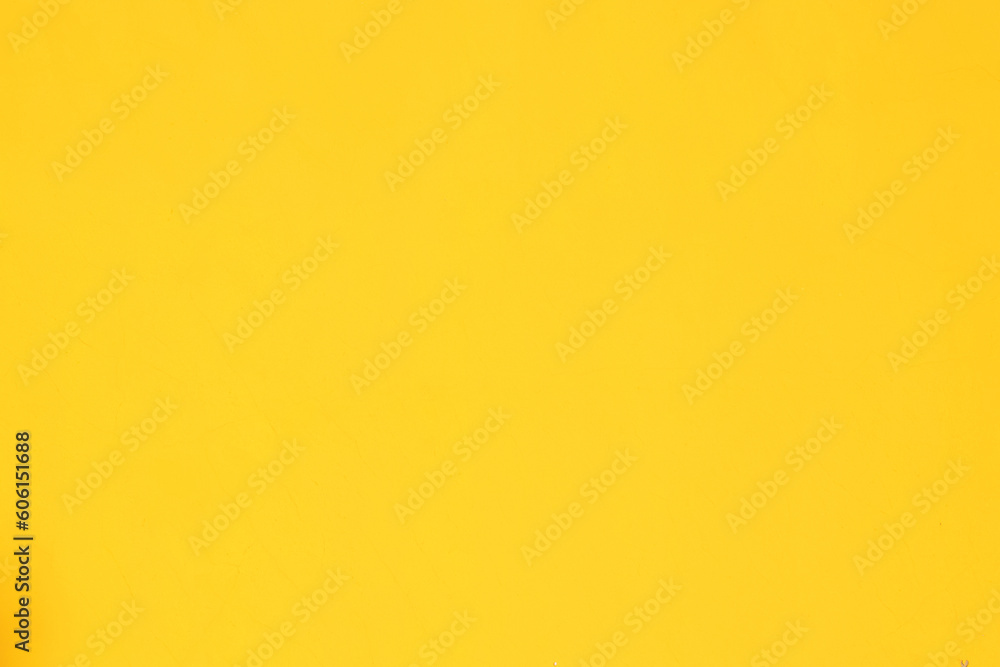 A background of a plain yellow wall A background of a plain yellow wall