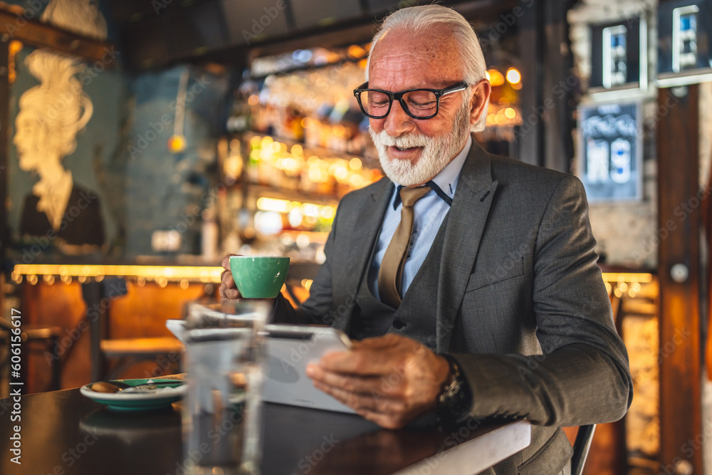 Senior man businessman business owner use digital tablet sit at cafe Senior man businessman business owner use digital tablet sit at cafe