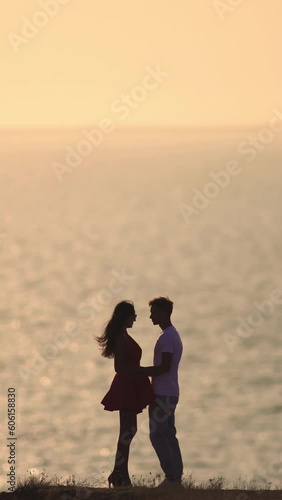 The romantic couple standing on the beautiful seascape background