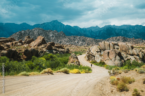 A gril walking down the road in Alabama Hills in California, United States close to Sierra Nevada Mountains