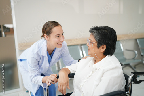 Friendly female doctor tries to support patient, holds her hands