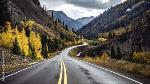 A Black Asphalt Road Leading into The Mountains During Autumn © Eirik Sørstrømmen