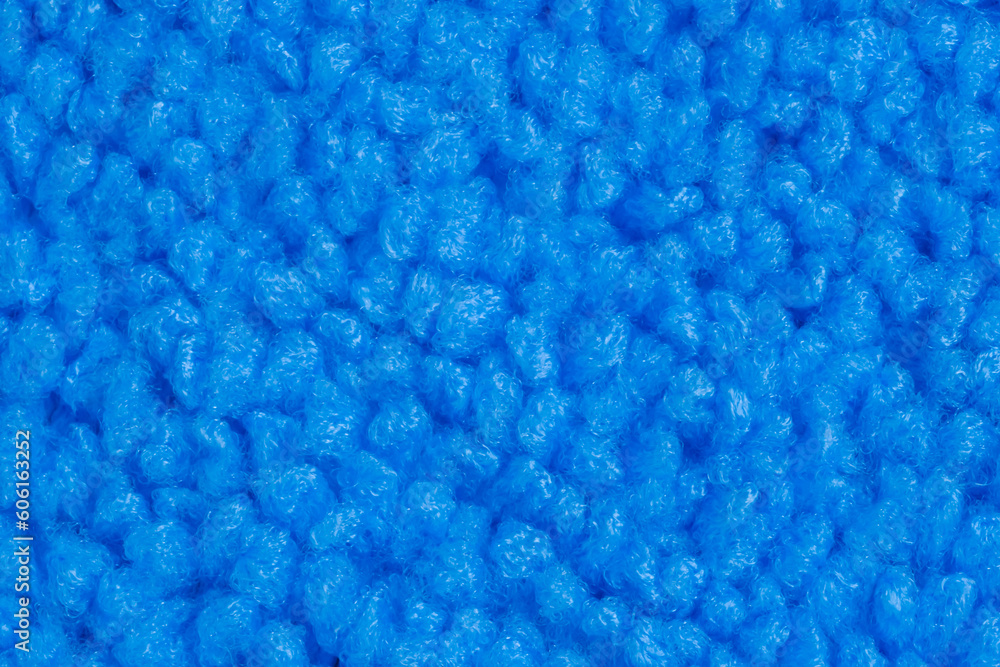 Top view: blue microfiber cleaning cloth - close up, macro. Texture, abstract, pattern, background and cleaning equipment for housework concept