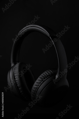 Foto Black headphones on a black background