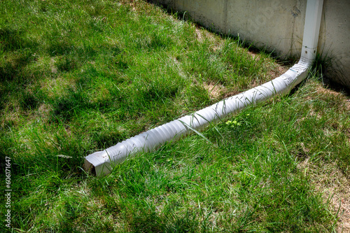 Gutter downspout, flexible rain gutter extension next to house 