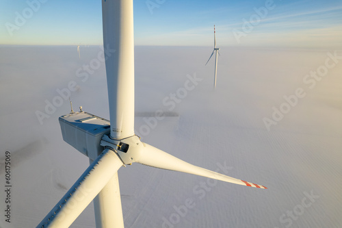 Aerial view of windfarm during winter foggy morning
