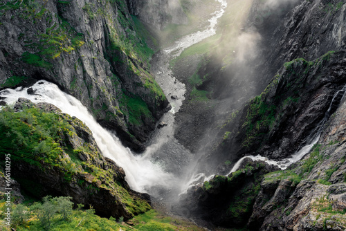 Amazing sunbeams passing through the mist created by the Voringfossen  waterfalls  Norway