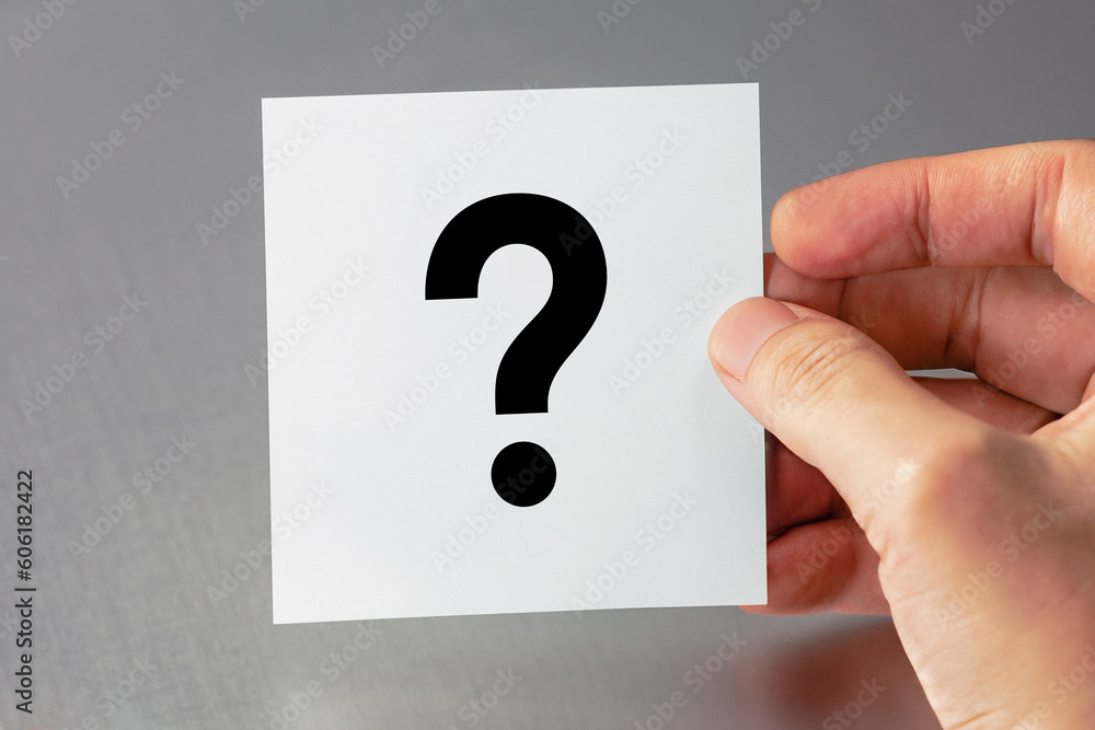 Question mark design. Hand holding white note paper with question mark. Question mark design. Hand holding white note paper with question mark.