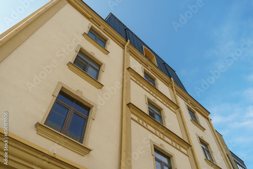 Modern multi-storey house in a new residential complex against the blue sky. The concept of mortgage housing lending and a happy family life. Beautiful multicolored house in the city