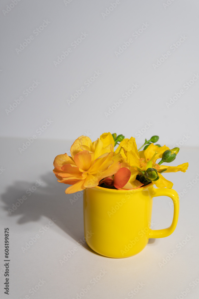 bouquet of yellow flowers in a yellow cup