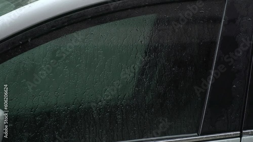 Wet car glass on back. Raindrop on car window