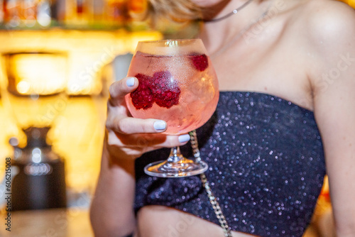 Woman holding pink cocktail
