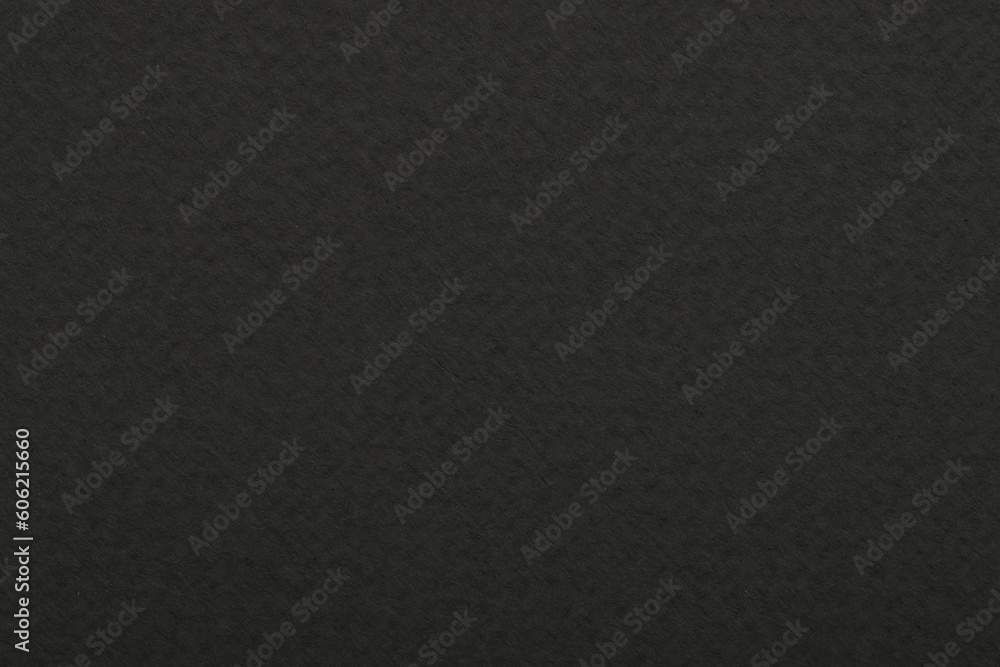 Texture of dark grey paper sheet as background, top view