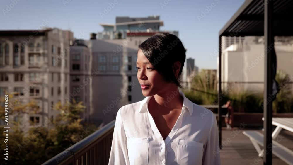 Portrait of a mixed ethnicity (Asian-African) business woman. Downtown buildings can be seen in the background. Portrait of a mixed ethnicity (Asian-African) business woman. Downtown buildings can be seen in the background.