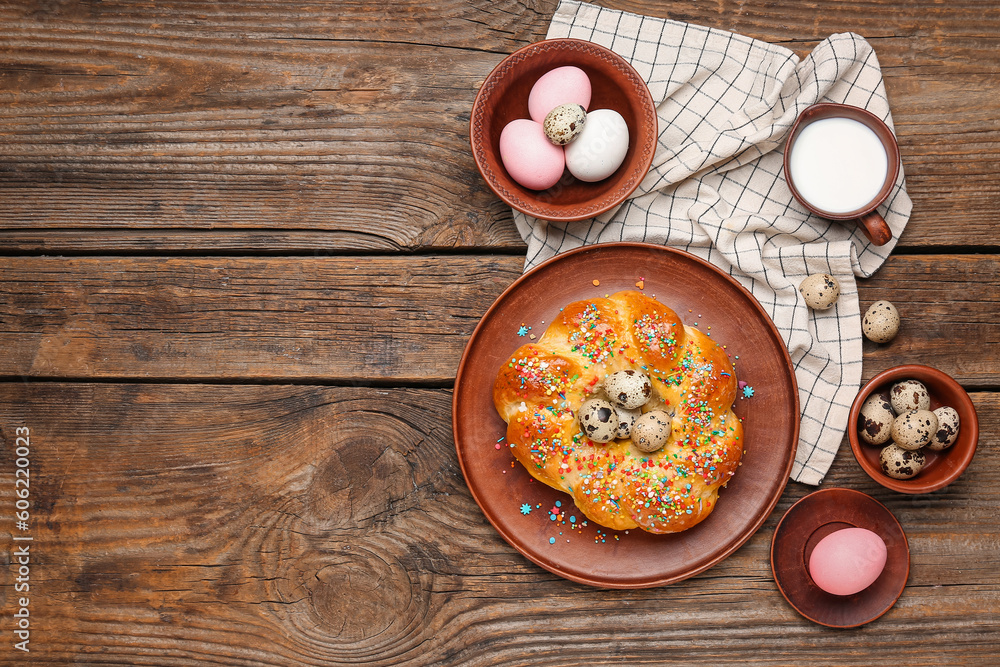 Composition with tasty Italian Easter bread, eggs and milk on wooden background Composition with tasty Italian Easter bread, eggs and milk on wooden background