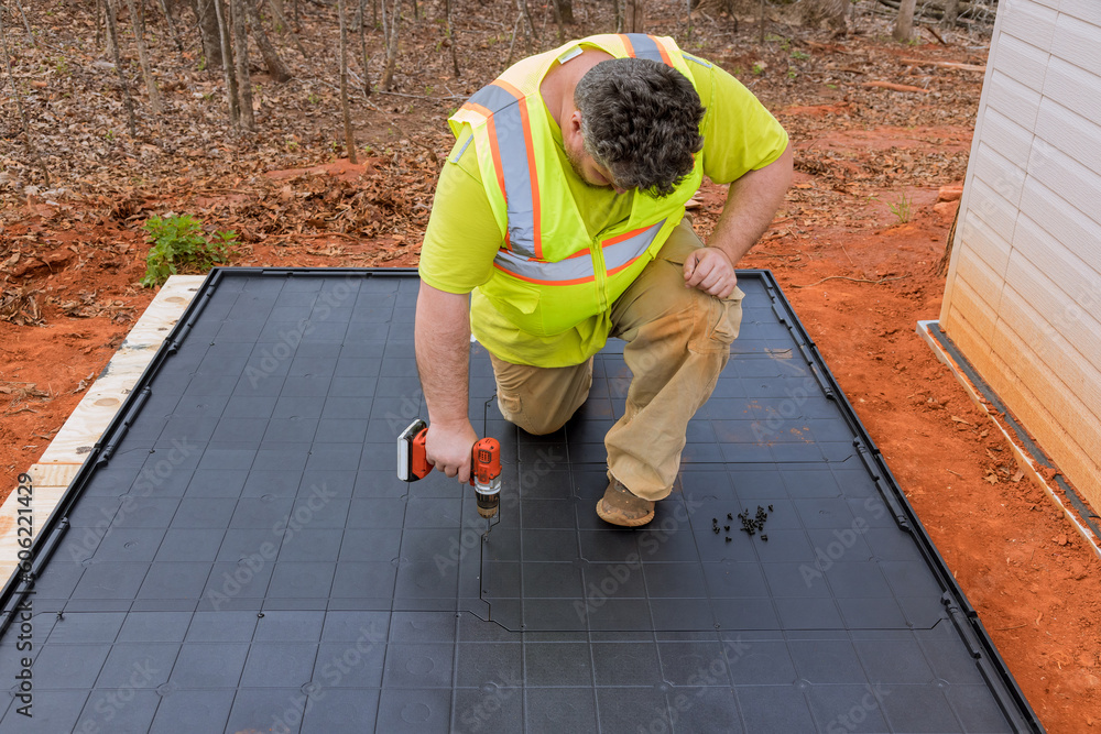 Image showcasing One of tasks involved in building plastic vinyl storage shed is ...