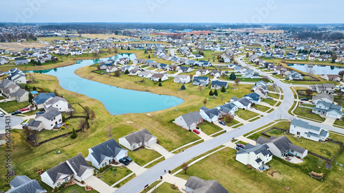 Drone aerial of suburban Midwest American neighborhood houses with pond © Nicholas J. Klein