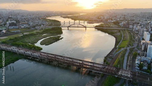 Osaka city aerial view at sunrise, Yodo river in Osaka city in Japan, Japanese metropolis, tourism in Japan, drone view of river and bridges in Osaka downtown photo