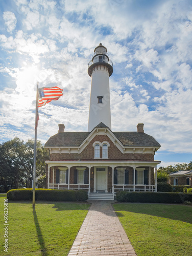 sunny day at the lighthouse in St. Simons, GA with an American flag blowing in the wind