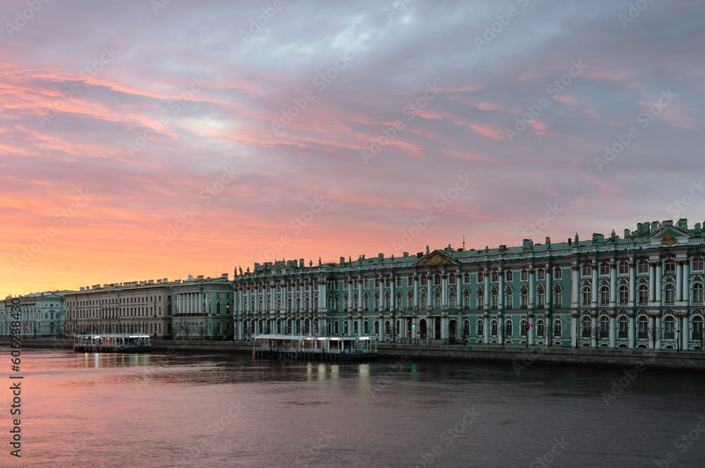 The building of the State Hermitage Museum on the Palace Embankment against the pink dawn sky, St. Petersburg, Russia