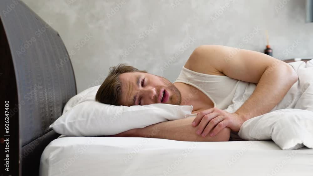 Fatigue Concept. Tired Young Man Lies In Bed At Home, Exhausted Guy Waking Up In Bedroom, Feeling Unwell, Having Headache Or Suffering Insomnia Fatigue Concept. Tired Young Man Lies In Bed At Home, Exhausted Guy Waking Up In Bedroom, Feeling Unwell, Having Headache Or Suffering Insomnia