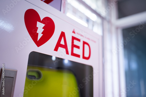 An automated external defibrillator (AED) in a white box is an emergency defibrillator for people in cardiac arrest photo