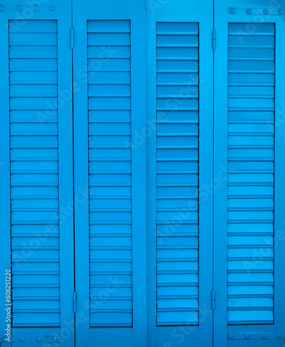 Blue shuttered window in the home as background. Texture