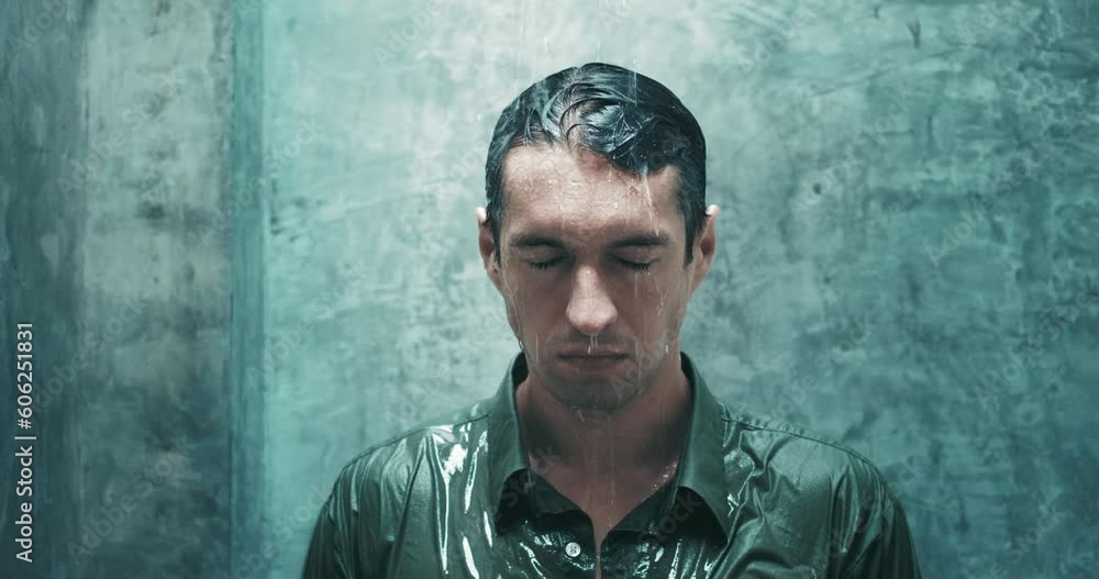 Depressed man in shirt stands under shower in bathroom and gets wet from water. Man experiencing strong emotional crisis, problems with mental health, standing in bathroom under shower in clothes Depressed man in shirt stands under shower in bathroom and gets wet from water. Man experiencing strong emotional crisis, problems with mental health, standing in bathroom under shower in clothes