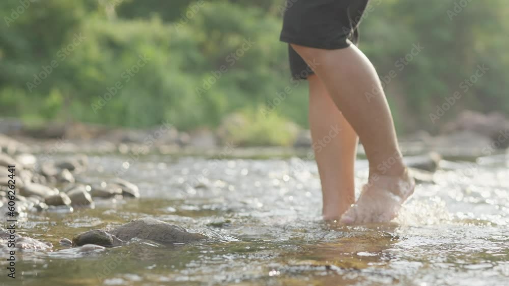 A boy wading in shallow water in the river A boy wading in shallow water in the river
