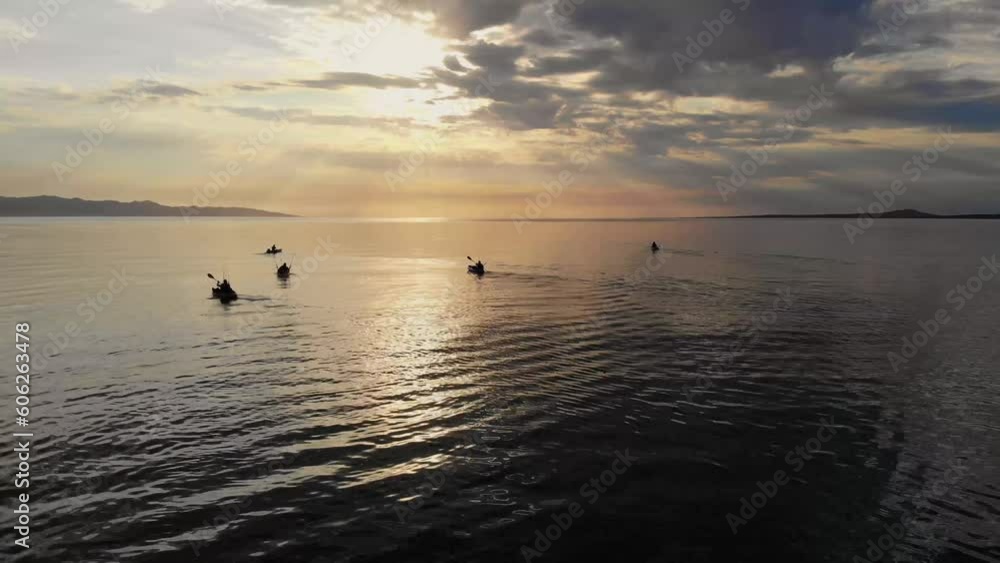 Group of kayak fishermans rowing to the sea in a beautiful sunrise in La Ventana Baja California Sur, Sea of Cortez Mexico Group of kayak fishermans rowing to the sea in a beautiful sunrise in La Ventana Baja California Sur, Sea of Cortez Mexico