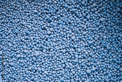 Chemical fertilizer pellets ready for use in agricultural plots, formula NPK 15-15-15 for decorating projects.