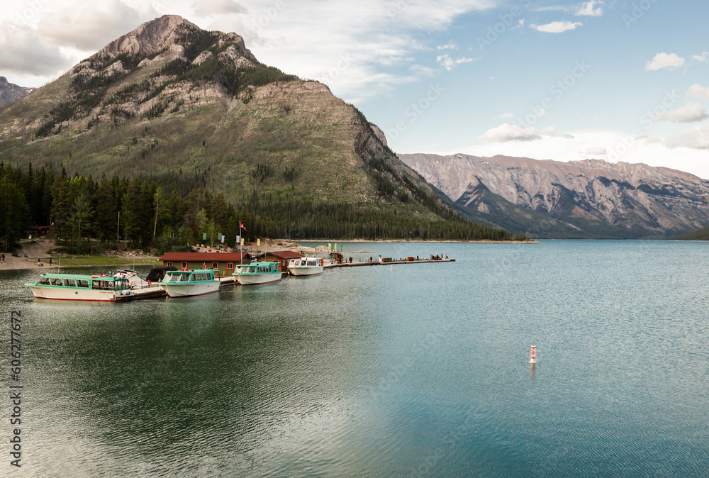 Summer vacation in the mountains. Active recreation - canoeing, kayaking - water sports. A tourist magnet on the lake Minnewanka, Banff National Park, Alberta, Canada