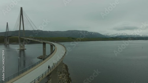 Cyclist and car approaching the Helgeland Bridge in Norway photo