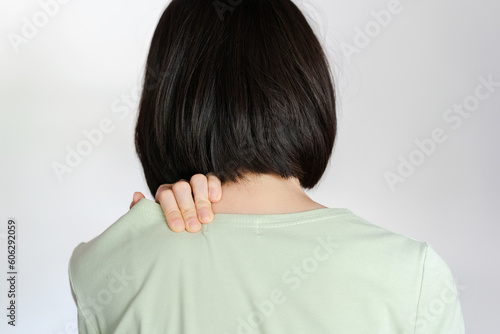 Woman showing pain in shoulder because of muscle inflammation.