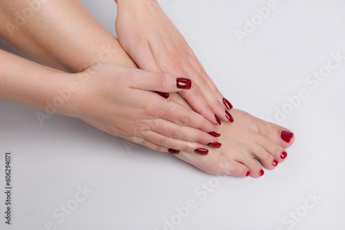 Fototapeta Naklejka Na Ścianę i Meble -  Close up of applying skin lotion on female feet