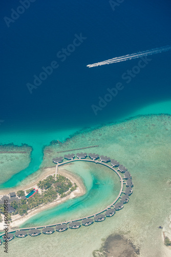 Aerial view on Maldives island atolls. Tropical islands lagoon in Maldives from aerial photography Summer exotic vacation holiday landscape background. Seaplane flying above travel landscape