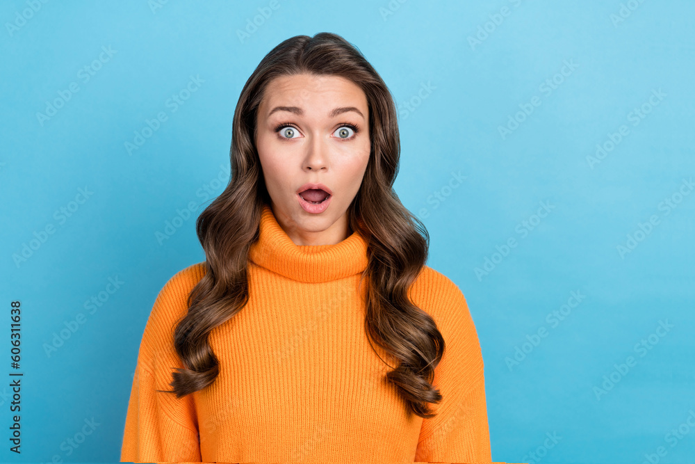Photo of impressed funny lady dressed orange pullover open mouth isolated blue color background Photo of impressed funny lady dressed orange pullover open mouth isolated blue color background