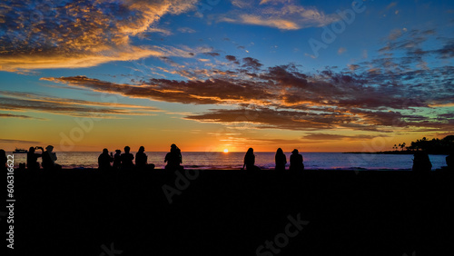 People silhoutted watching the sunset at the Kona Coast of the Big Island Hawaii