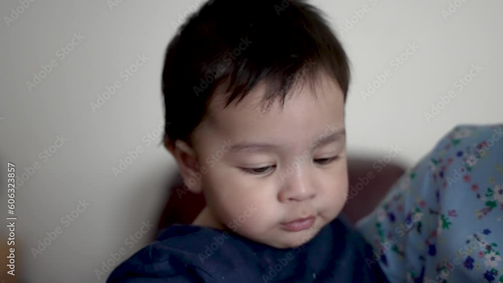 Young Baby Toddler Slowly Turning Head As He's Being Held By His Mother Indoors. Slow Motion Young Baby Toddler Slowly Turning Head As He's Being Held By His Mother Indoors. Slow Motion