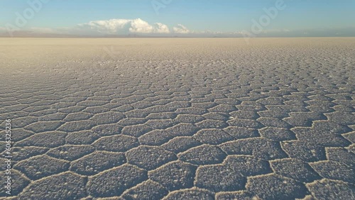 Drone flying speedy above surface of Salar de Uyuni salt flat, Altiplano, Bolivia