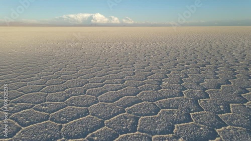 Drone flying speedy above surface of Salar de Uyuni salt flat, Altiplano, Bolivia photo