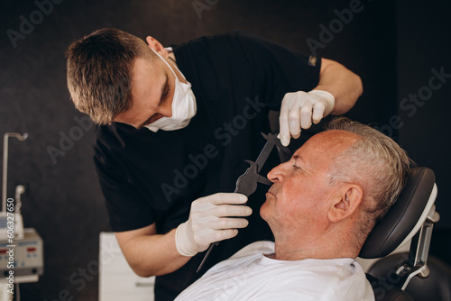 Old man visiting male doctor for plastic surgery