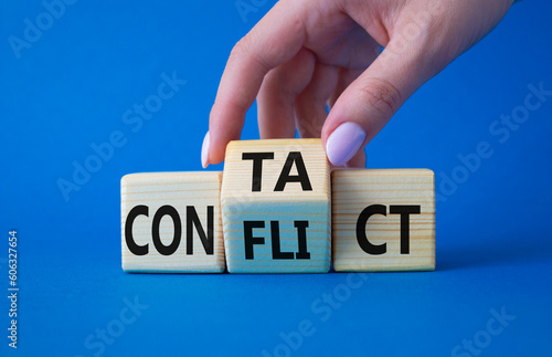 Contact and Conflict symbol. Businessman hand turns wooden cubes with words Contact and Conflict. Beautiful blue background. Contact and Conflict and business concept. Copy space