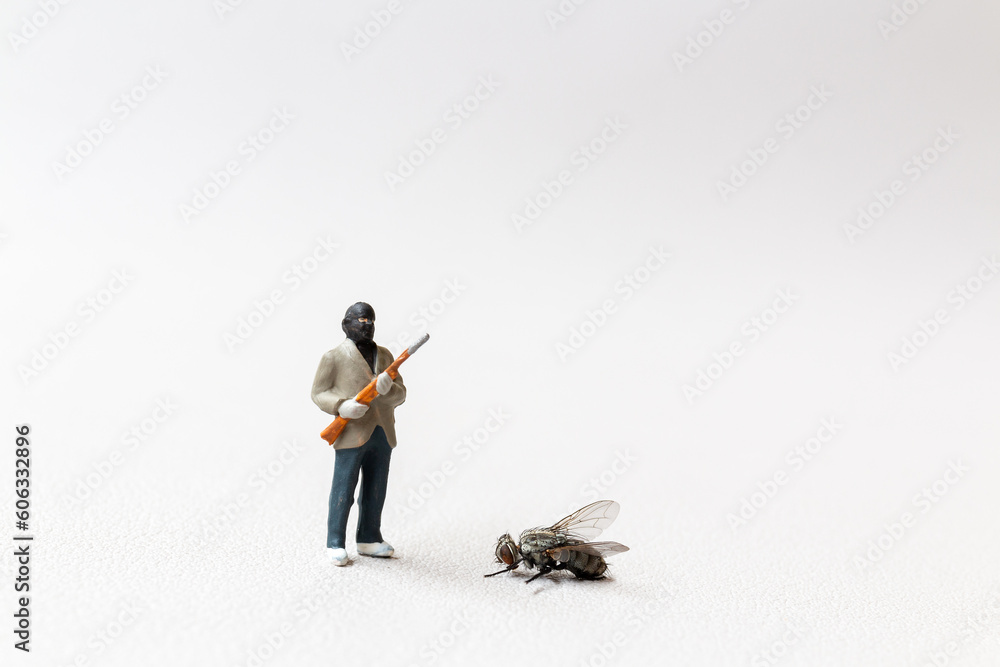 Miniature people , A Man with a shotgun killed a fly. Miniature people , A Man with a shotgun killed a fly.