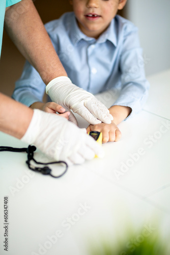 Close up of a doctor checking little boys blood pressure