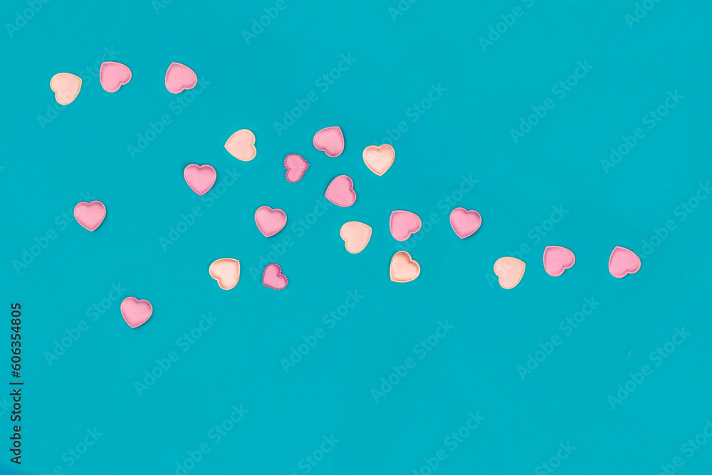 Satin hearts scattered on a blue background Satin hearts scattered on a blue background