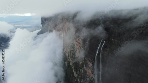 Drone flying along Tepuy Roraima huge wall mountain with waterfalls, The mount in white clouds, Venezuela, Canaima National Park, South America